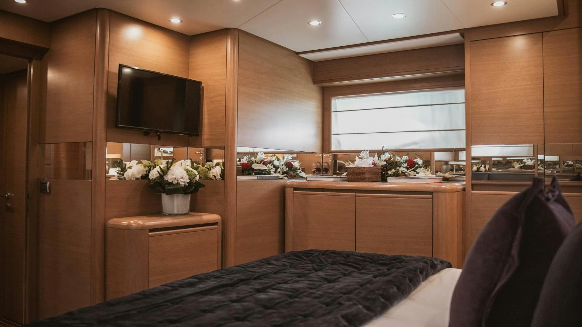 a room with a bed and tv aboard MOKI Yacht for Sale