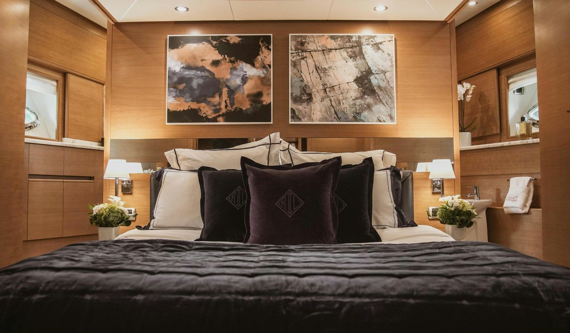 a bed with a black bed spread aboard MOKI Yacht for Sale