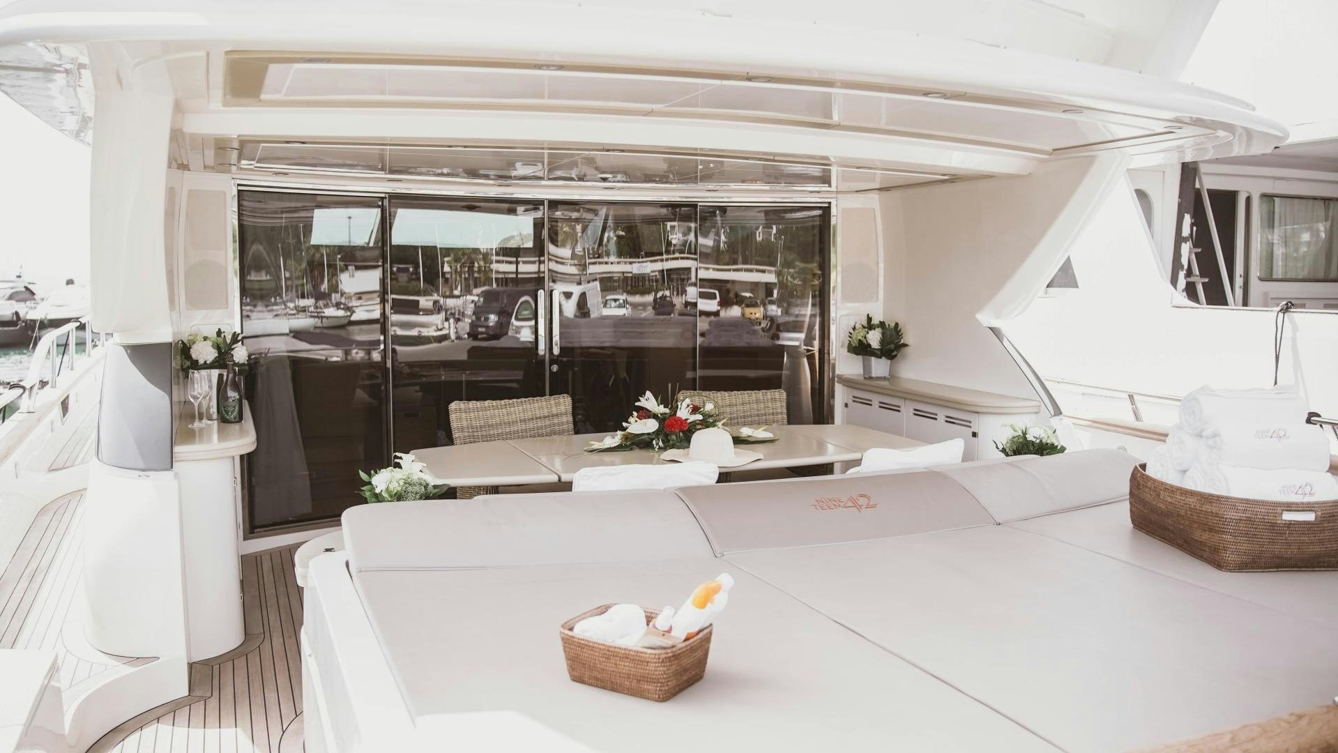 a room with a table and chairs aboard MOKI Yacht for Sale