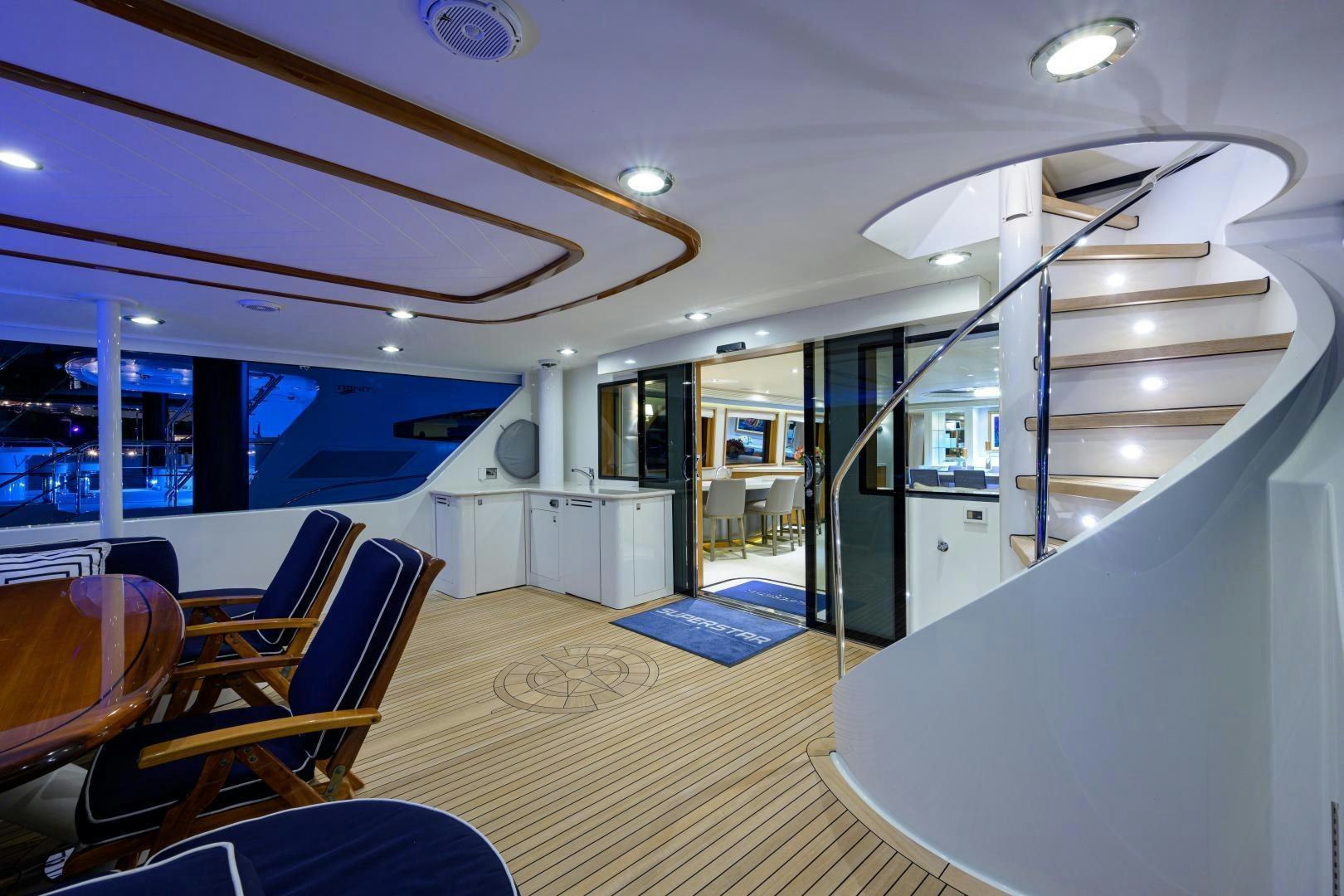 inside of a building with a swimming pool and a large window aboard SUPERSTAR Yacht for Sale