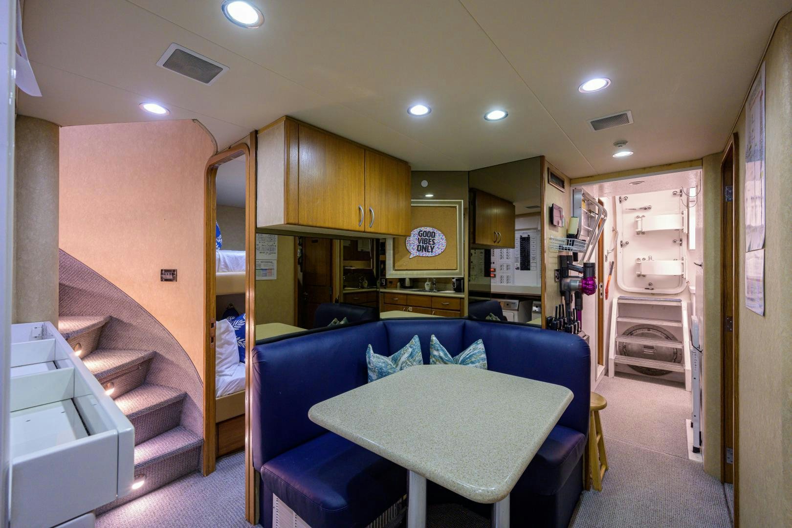 a living room with a blue couch aboard SUPERSTAR Yacht for Sale