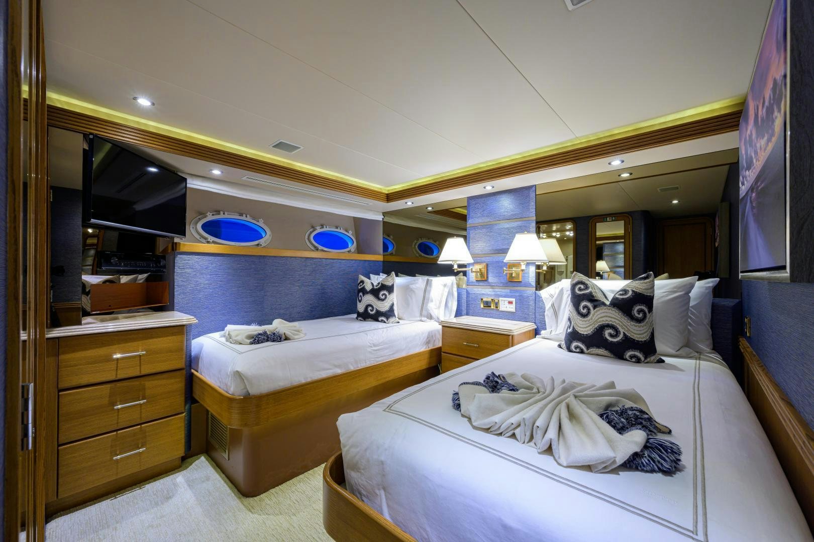 a room with a couple beds aboard SUPERSTAR Yacht for Sale