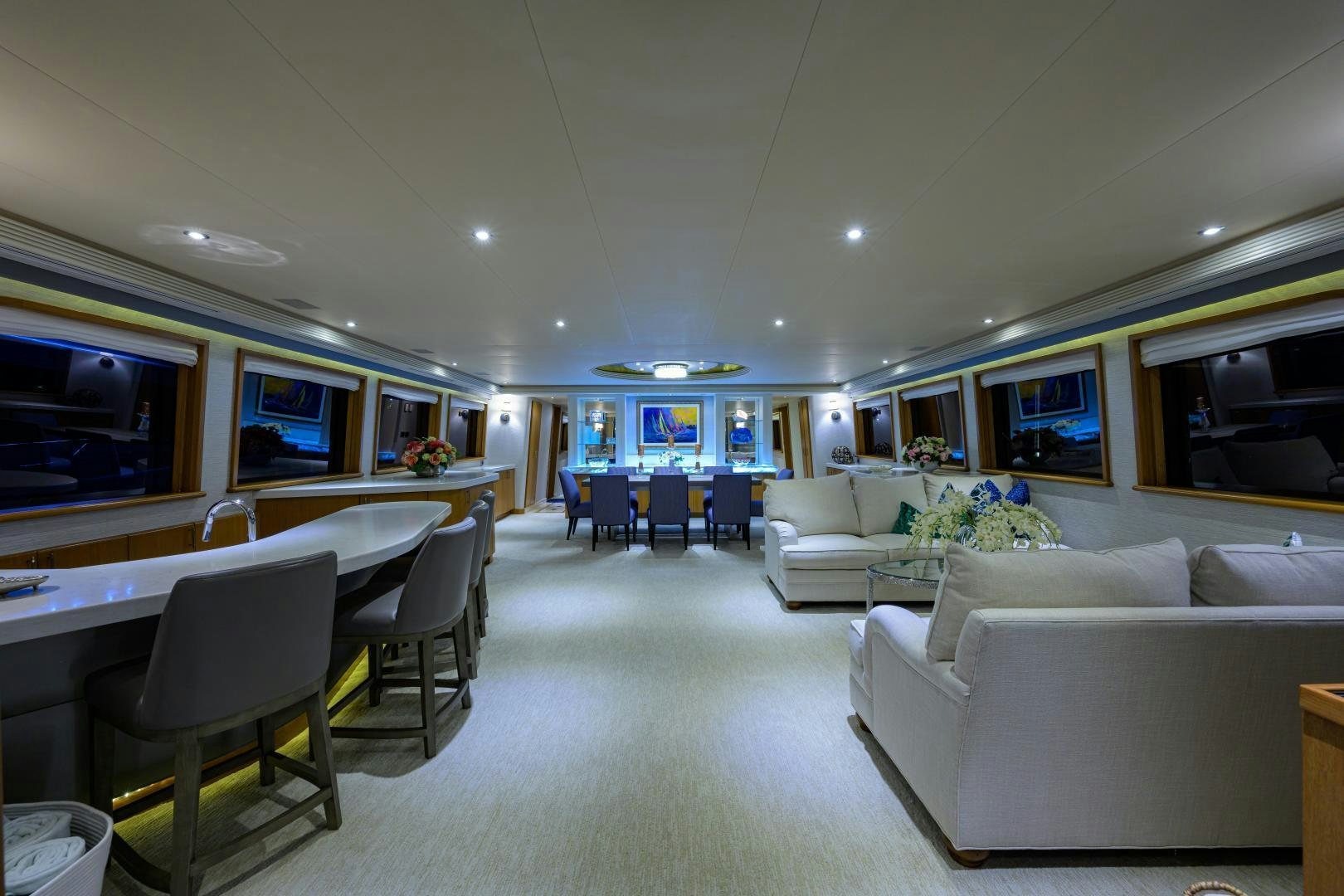a large living room with a white couch and a large table aboard SUPERSTAR Yacht for Sale