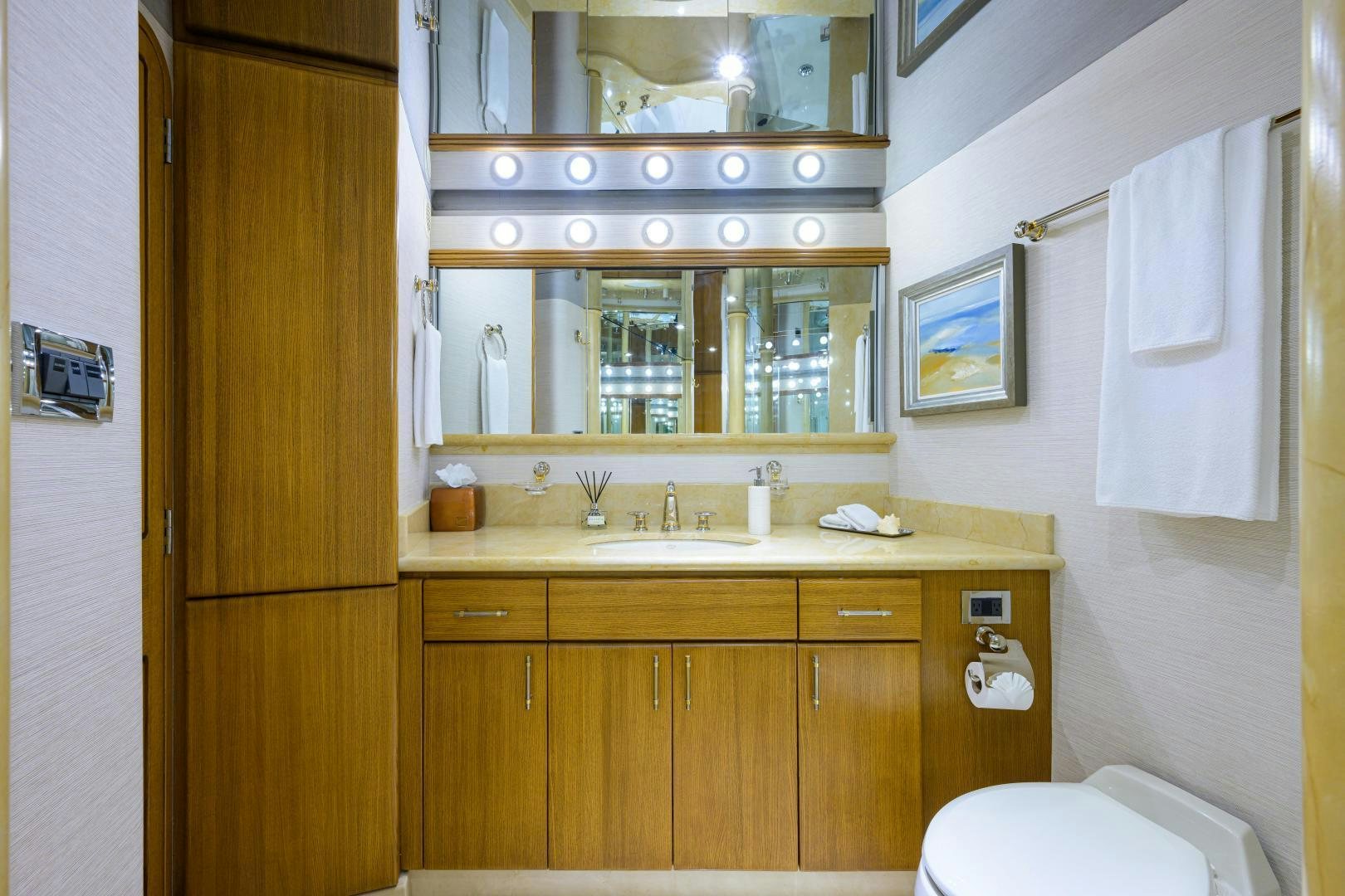 a bathroom with wooden cabinets aboard SUPERSTAR Yacht for Sale