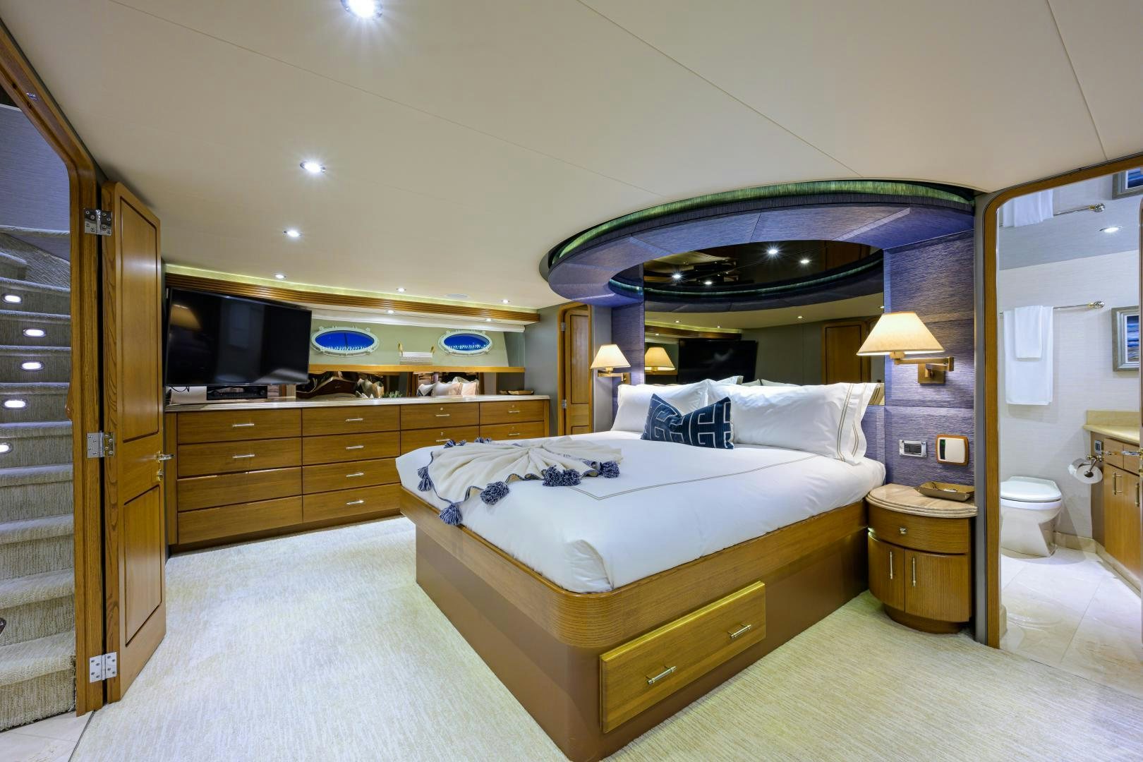 a hotel room with a bed and a mirror aboard SUPERSTAR Yacht for Sale