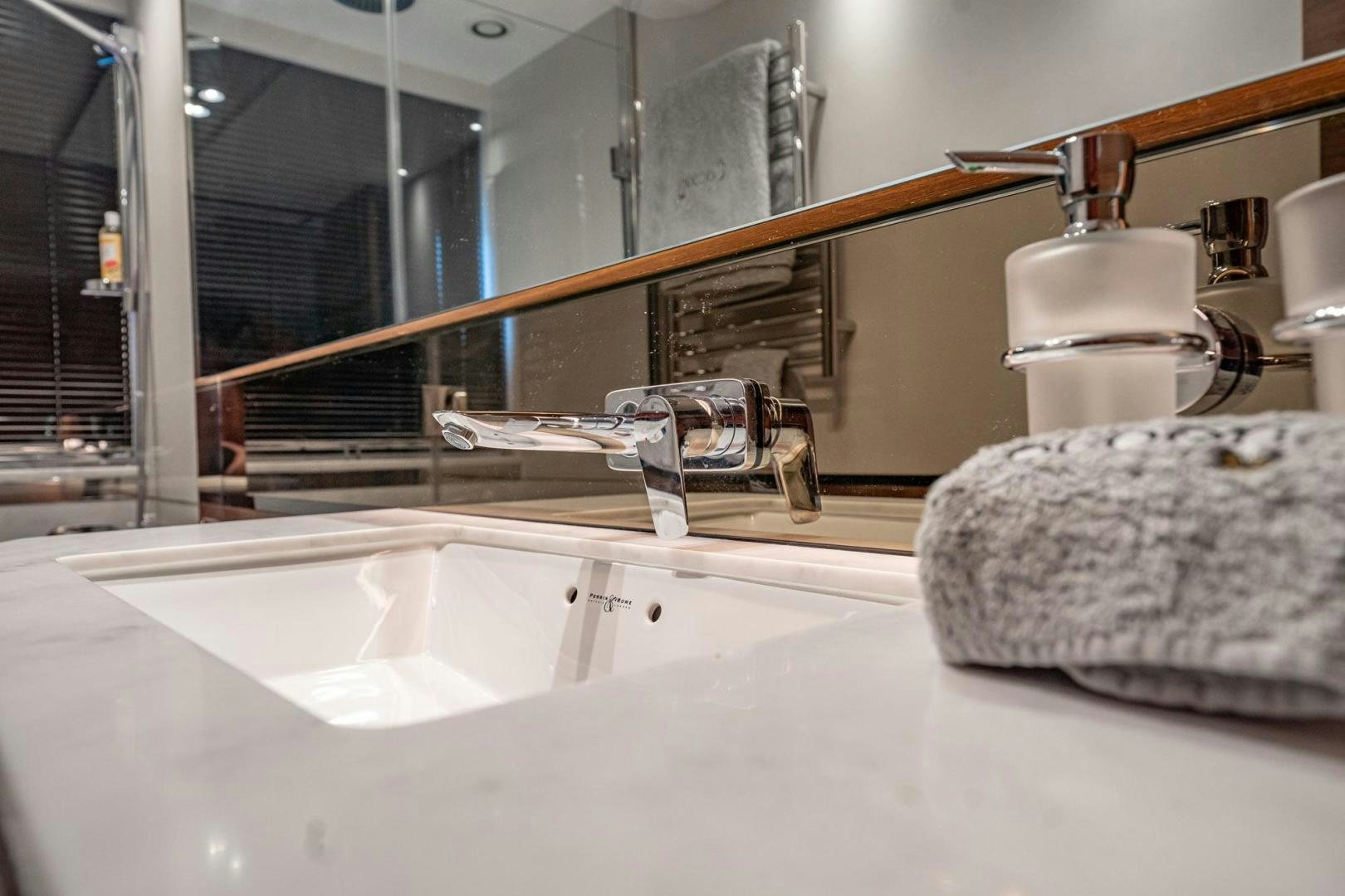 a bathroom sink with a towel rack aboard COCOON Yacht for Sale