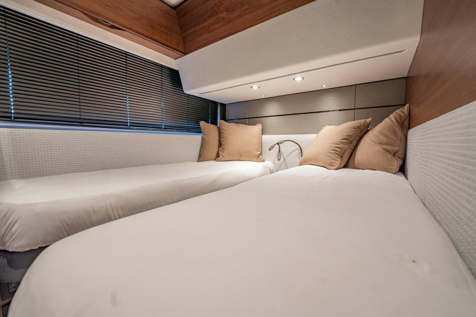 a bed with pillows aboard COCOON Yacht for Sale