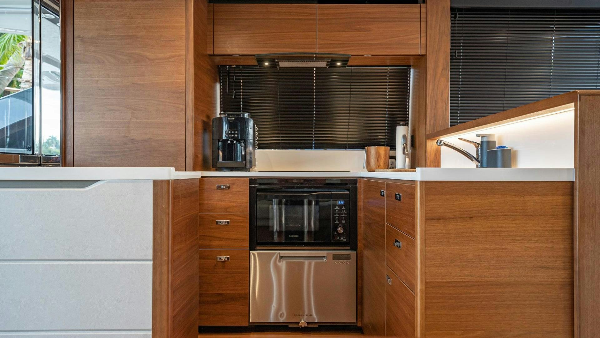 a kitchen with wooden cabinets aboard COCOON Yacht for Sale