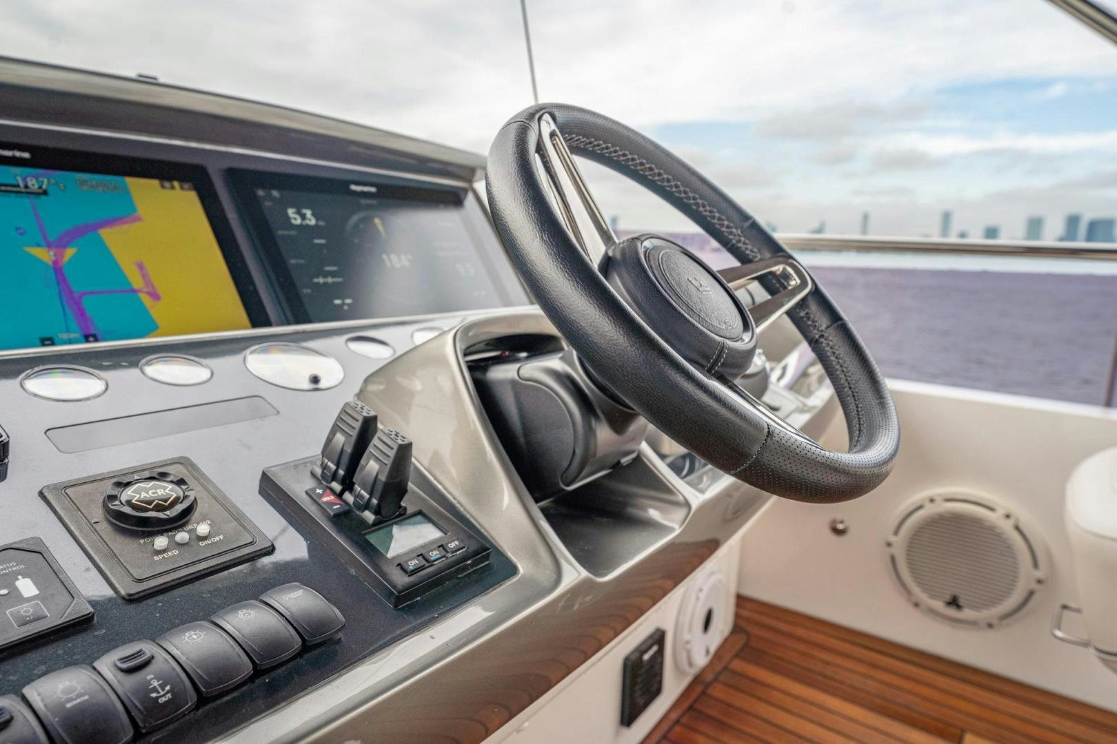 a steering wheel and dashboard of a car aboard COCOON Yacht for Sale