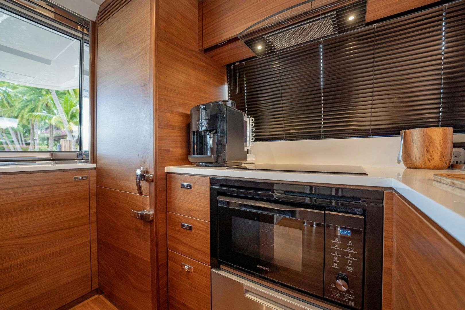 a kitchen with wooden cabinets aboard COCOON Yacht for Sale