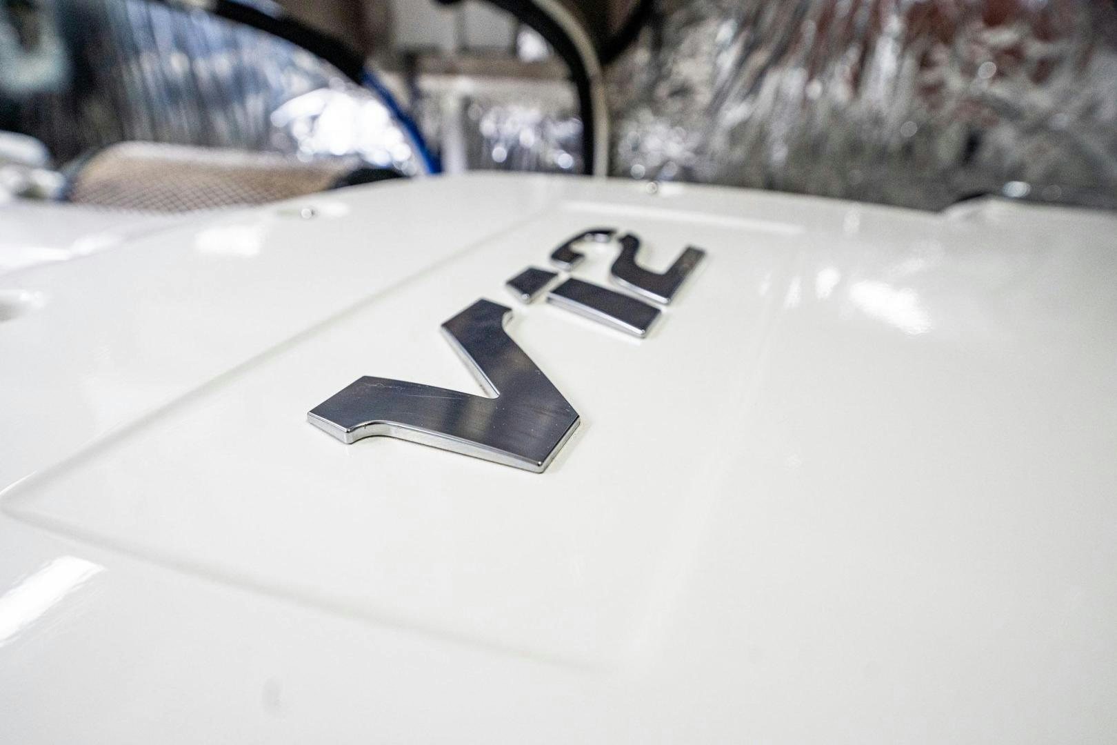 a white car with a black logo on it aboard COCOON Yacht for Sale