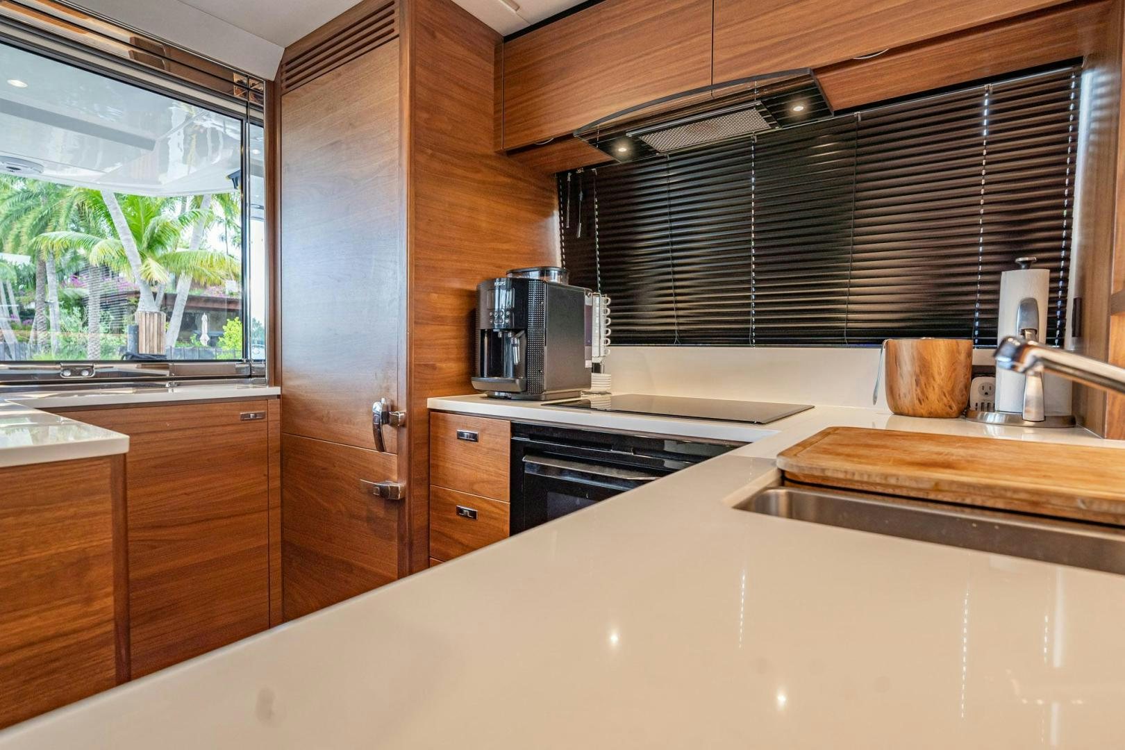 a kitchen with wooden cabinets aboard COCOON Yacht for Sale