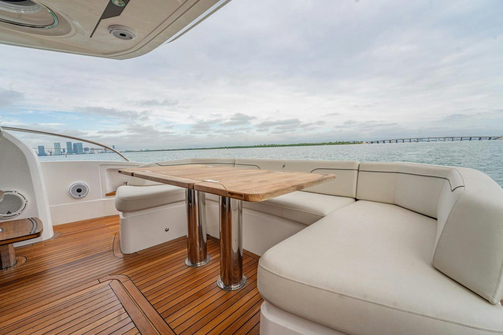 a table and a couch on a boat in the water aboard COCOON Yacht for Sale