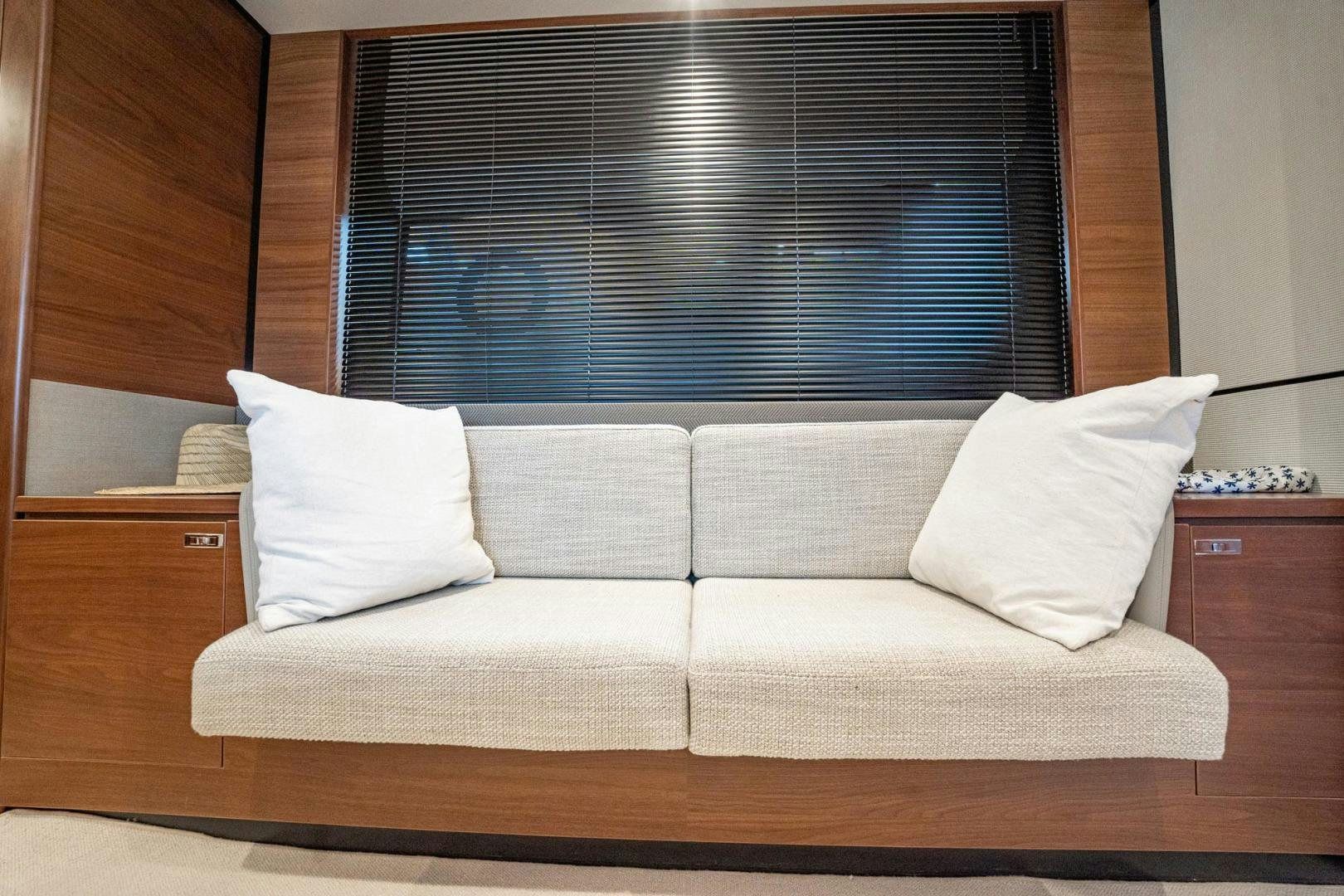 a couch with pillows aboard COCOON Yacht for Sale