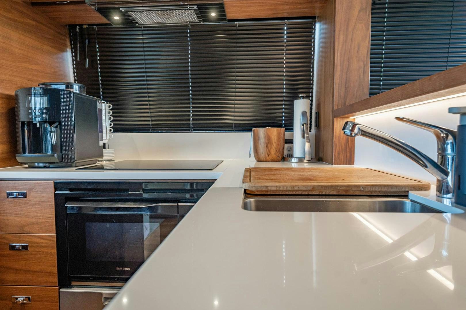 a kitchen with a sink and a microwave aboard COCOON Yacht for Sale
