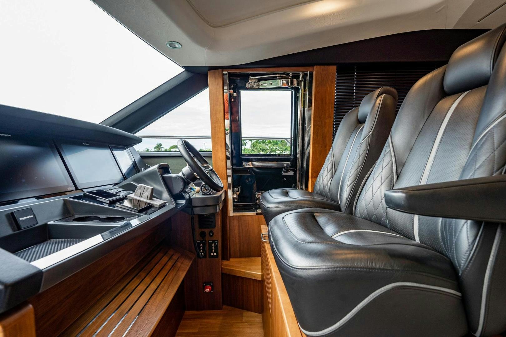 a room with a piano and a chair aboard COCOON Yacht for Sale