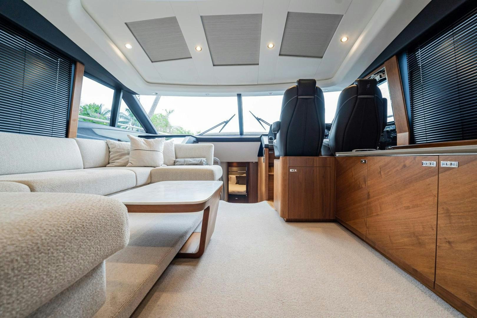 a room with a couch and a table and a window aboard COCOON Yacht for Sale