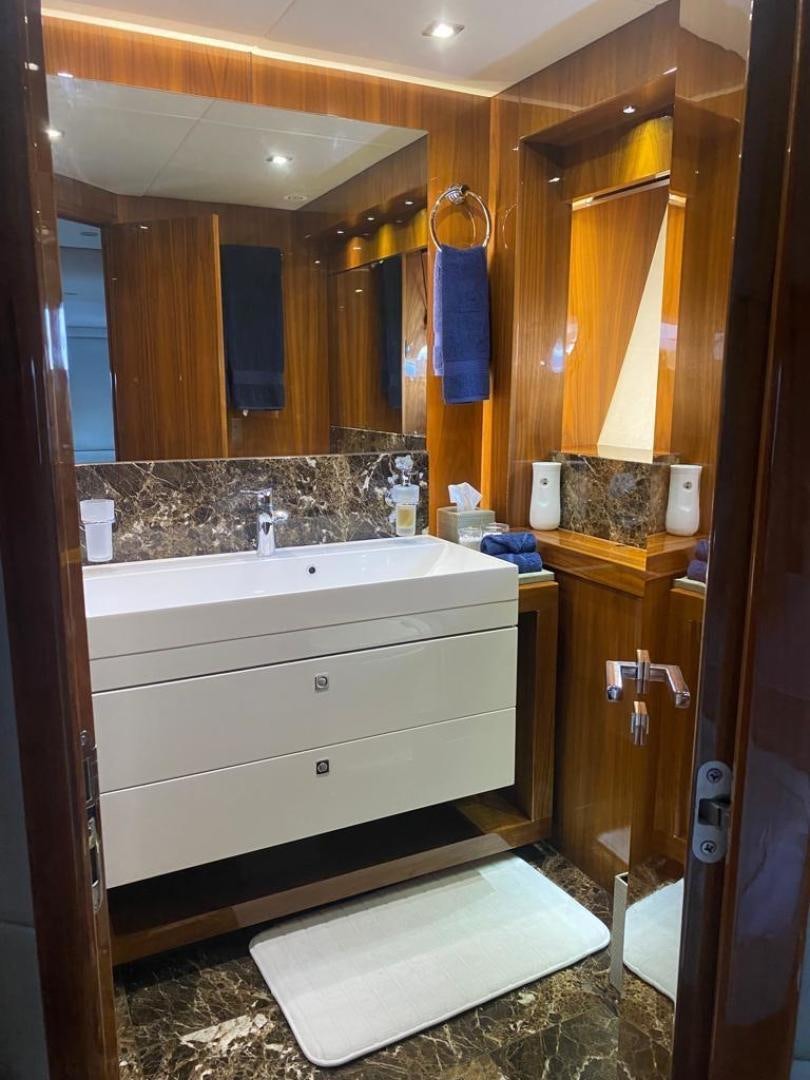 a bathroom with a large mirror aboard RIII Yacht for Sale