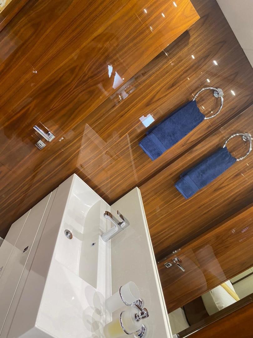 a bathroom with a blue towel from the ceiling aboard RIII Yacht for Sale