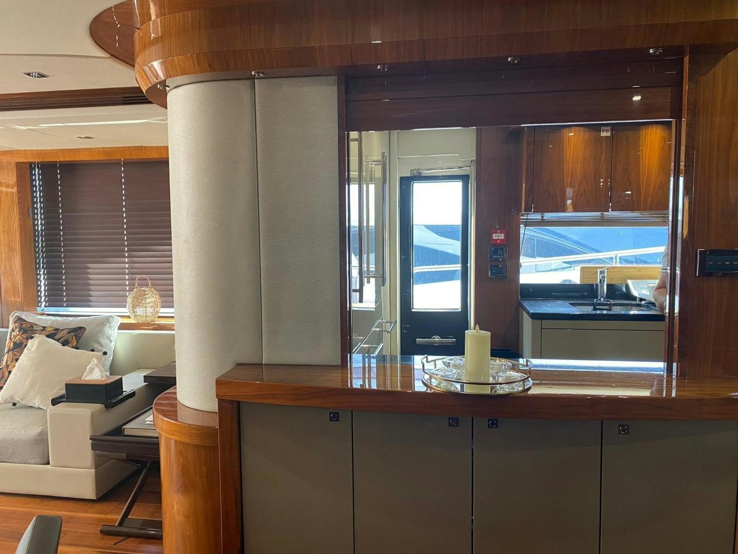 a room with a window and a desk with a view of the water aboard RIII Yacht for Sale