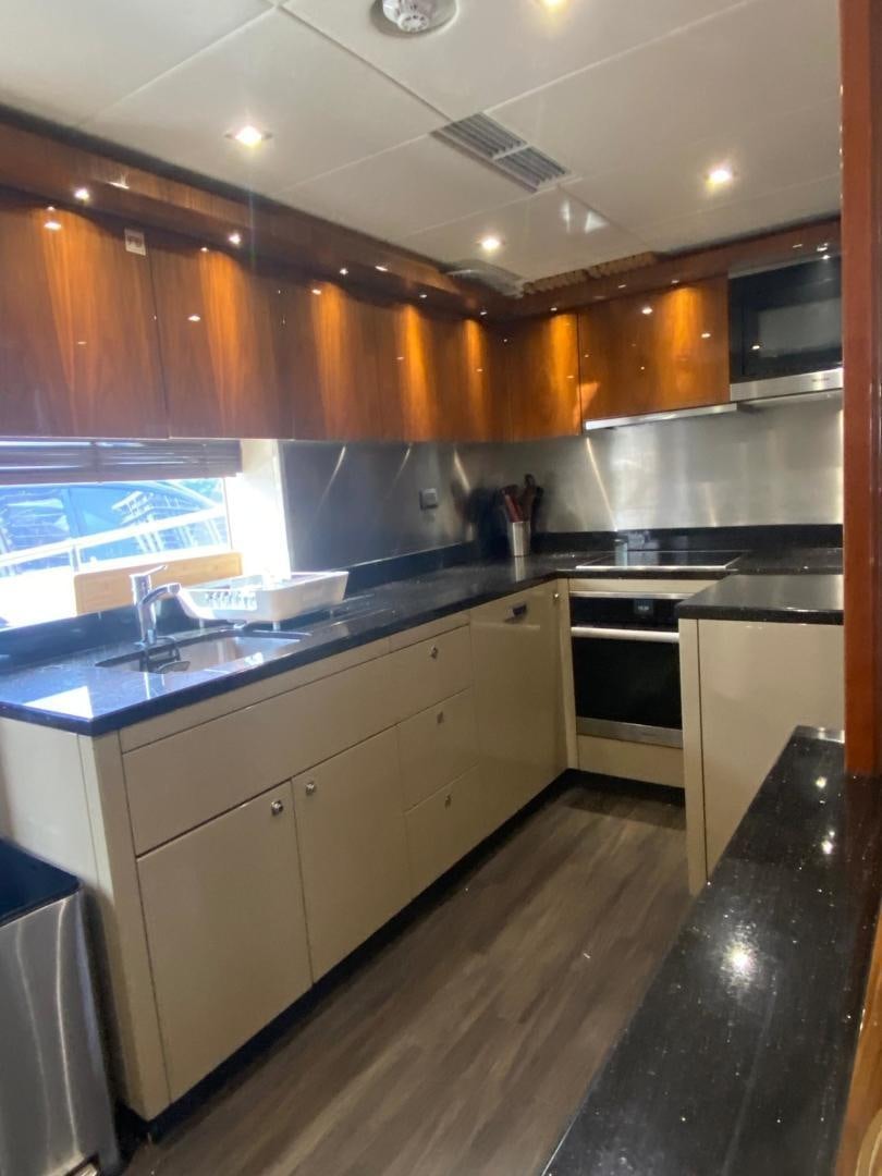 a kitchen with wooden cabinets aboard RIII Yacht for Sale