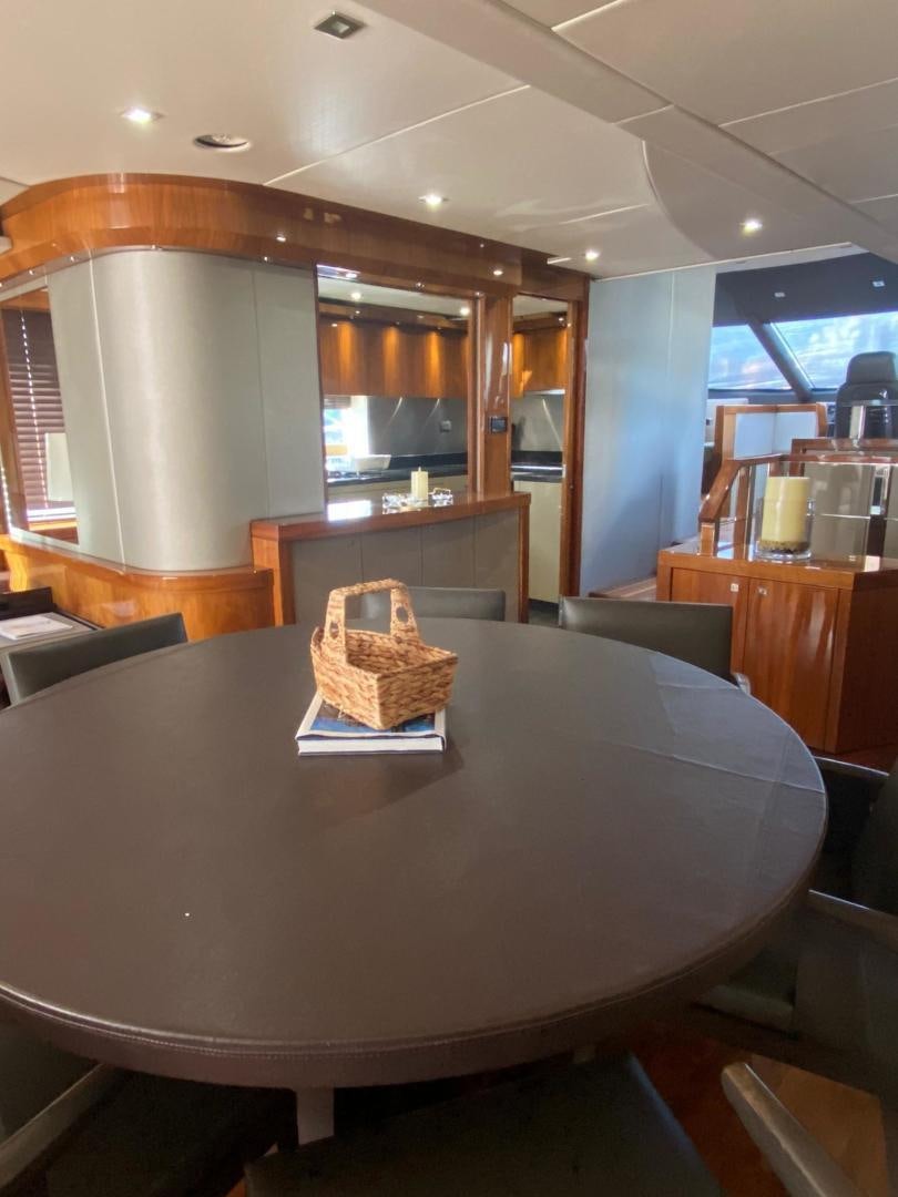 a large kitchen with a round table aboard RIII Yacht for Sale