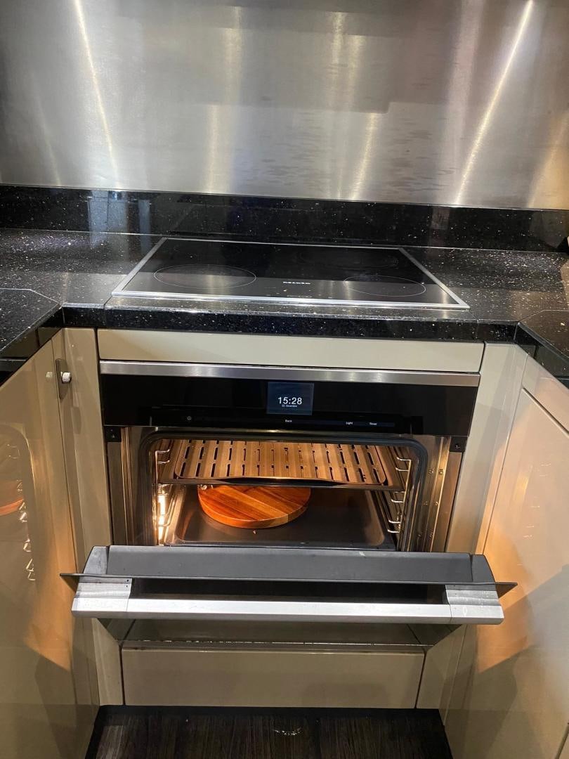 a hot dog is being cooked in an oven aboard RIII Yacht for Sale