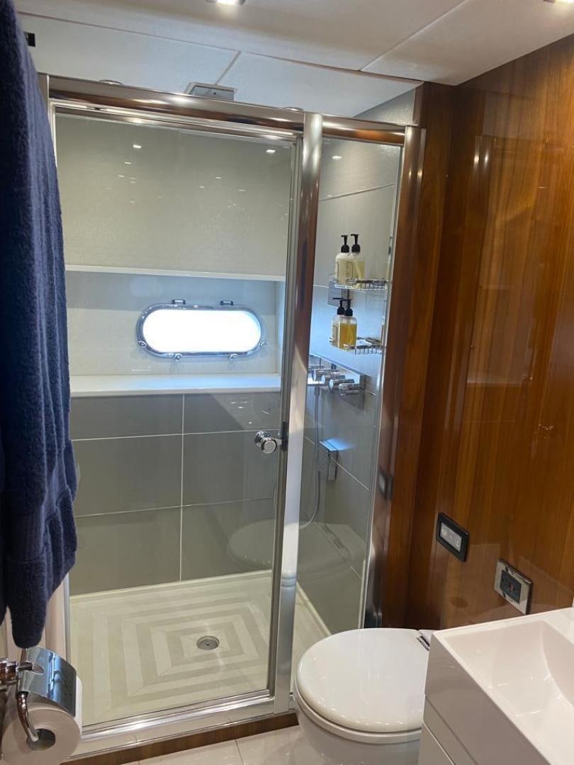 a bathroom with a glass shower aboard RIII Yacht for Sale