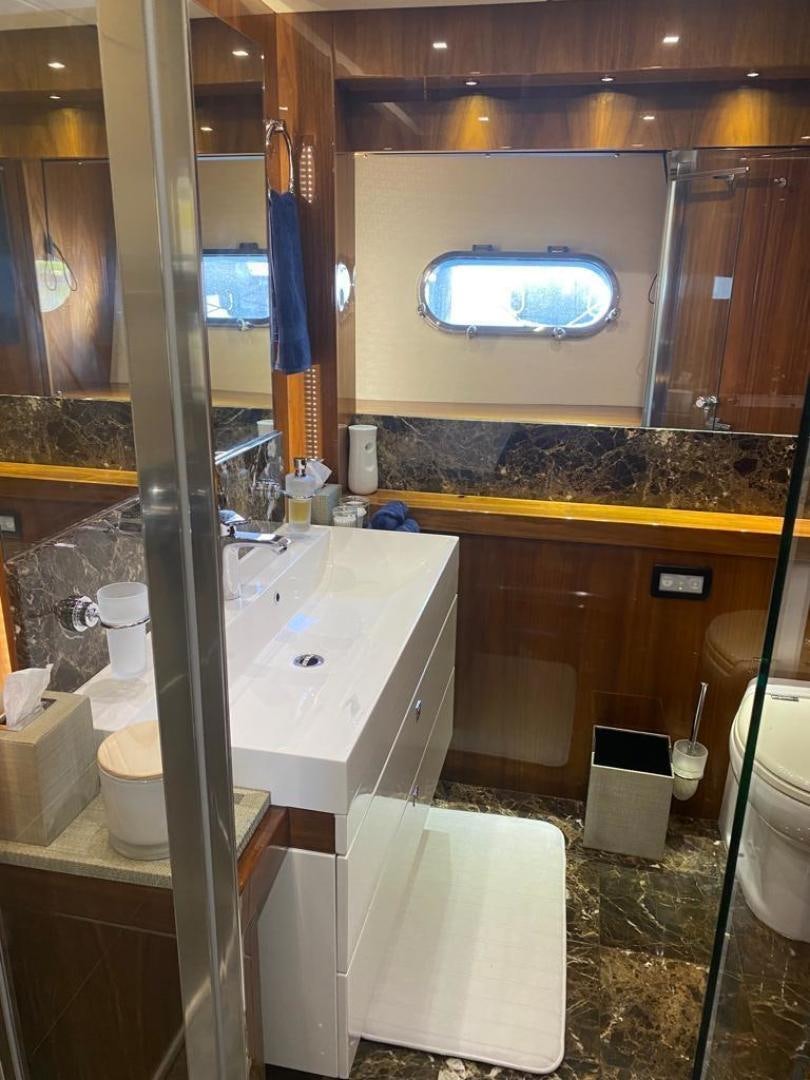 a bathroom with a large mirror aboard RIII Yacht for Sale
