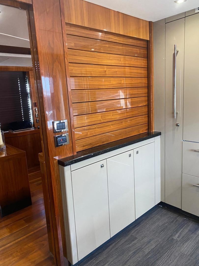a room with wooden cabinets aboard RIII Yacht for Sale