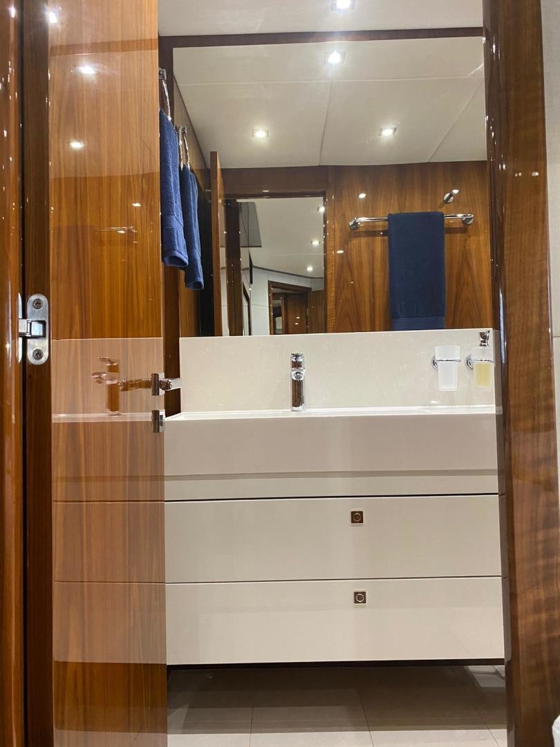 a bathroom with a large mirror aboard RIII Yacht for Sale