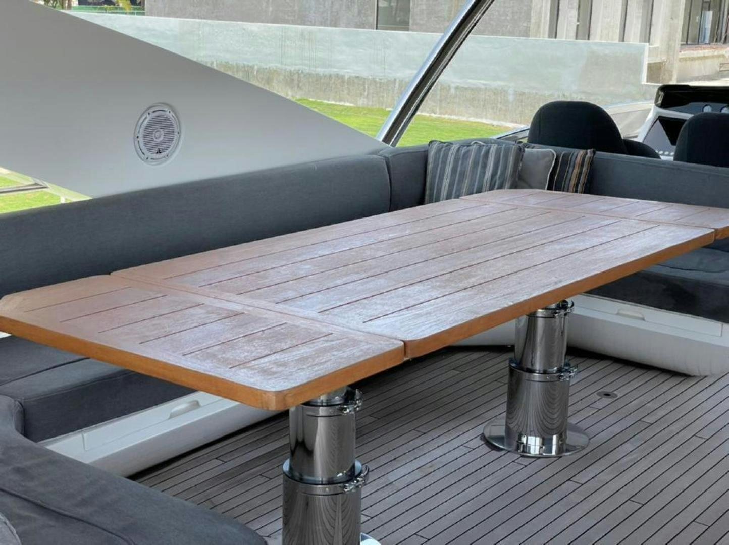 a wood table with a metal railing aboard RIII Yacht for Sale