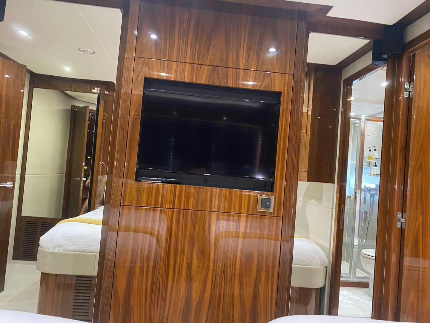 a room with a tv and a table aboard RIII Yacht for Sale