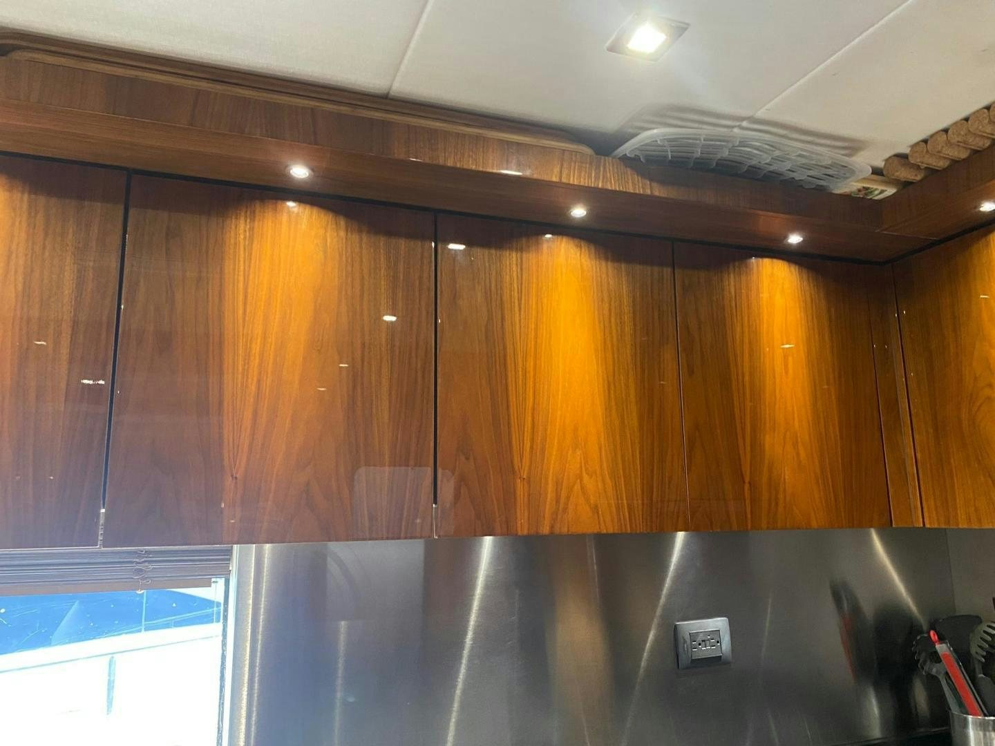 a kitchen with wooden cabinets aboard RIII Yacht for Sale
