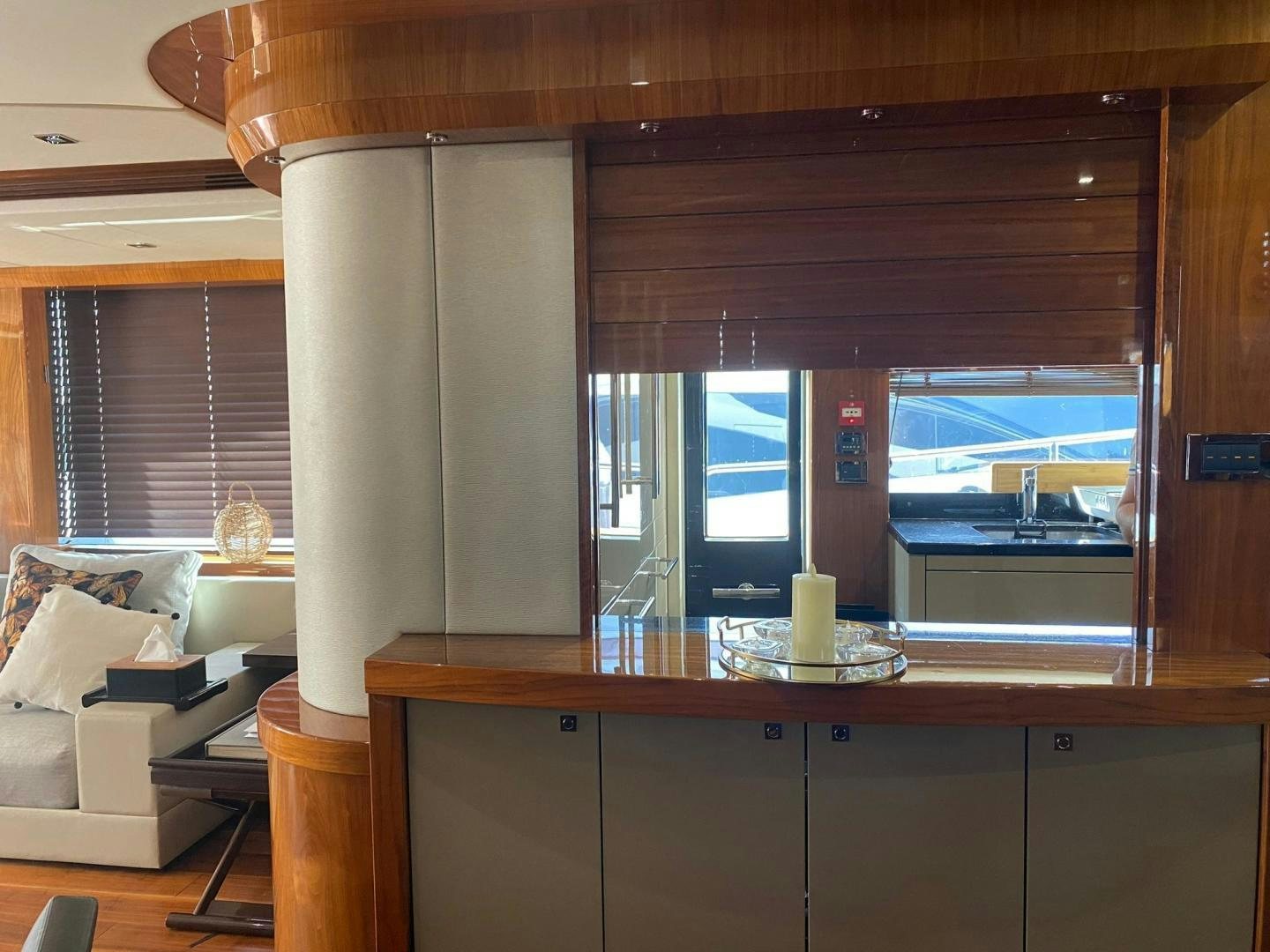 a room with a window and a table with a view of the water aboard RIII Yacht for Sale