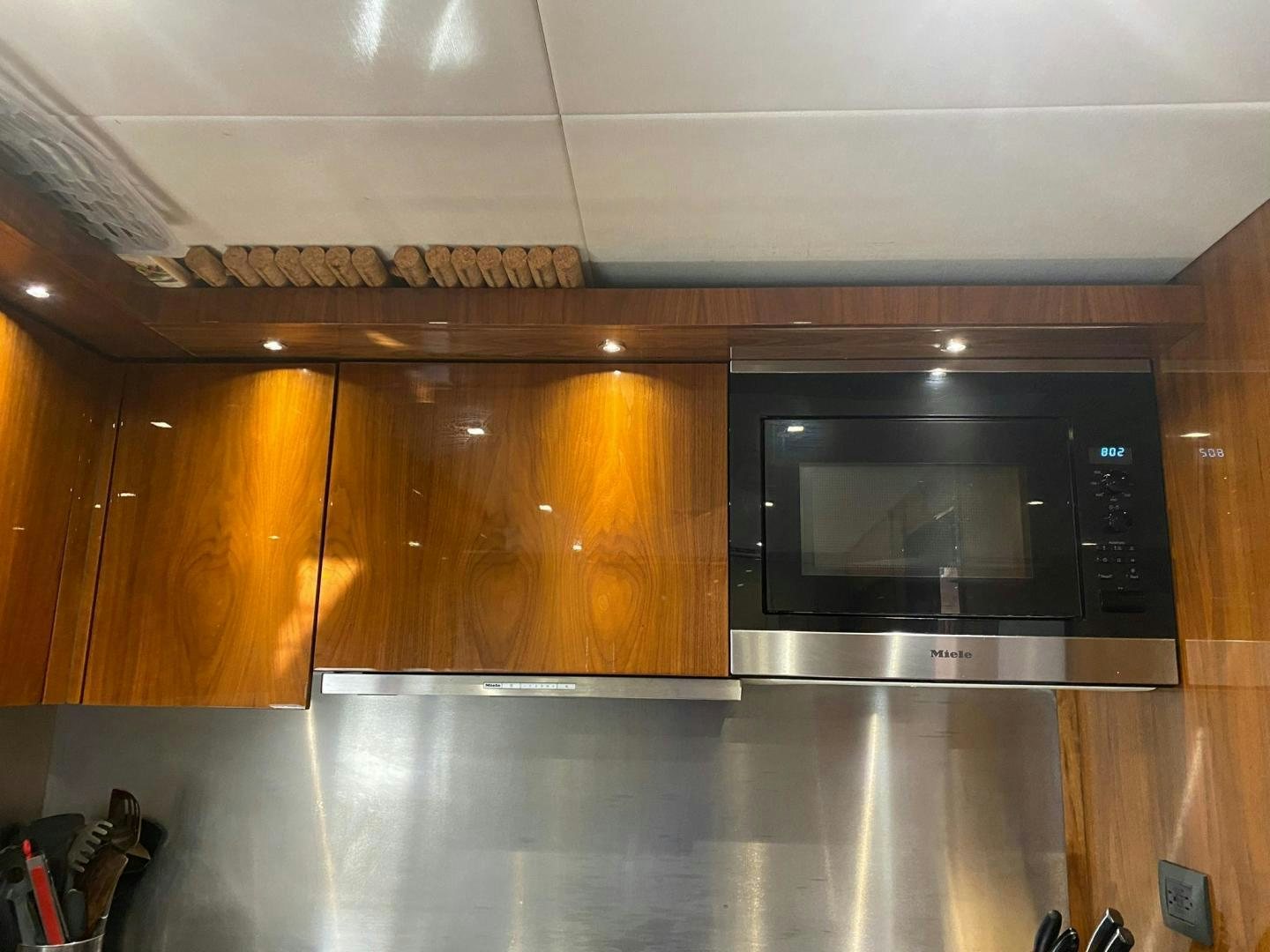 a kitchen with wooden cabinets aboard RIII Yacht for Sale
