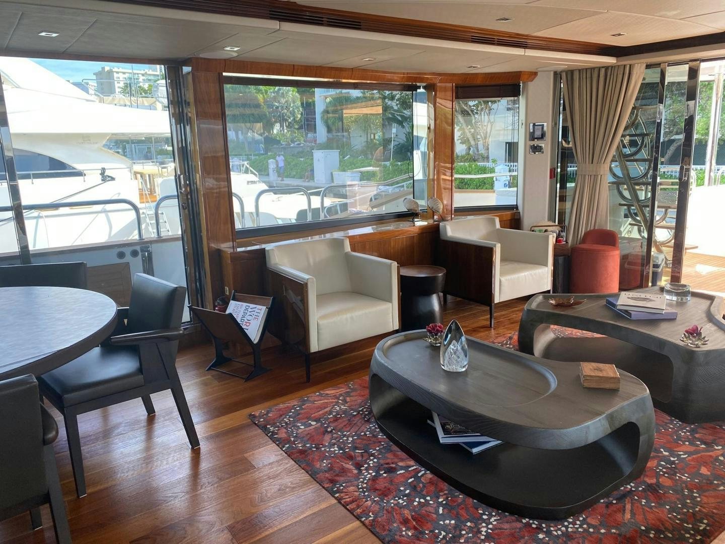 a room with a couch and a table and chairs aboard RIII Yacht for Sale