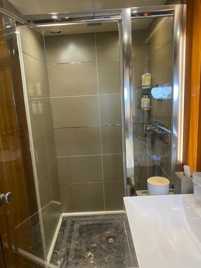a shower unit in a bathroom aboard RIII Yacht for Sale