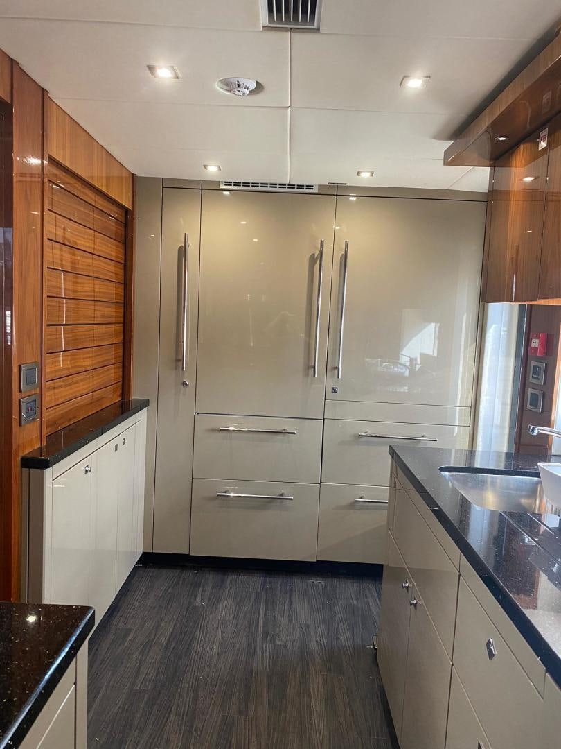 a kitchen with a refrigerator aboard RIII Yacht for Sale