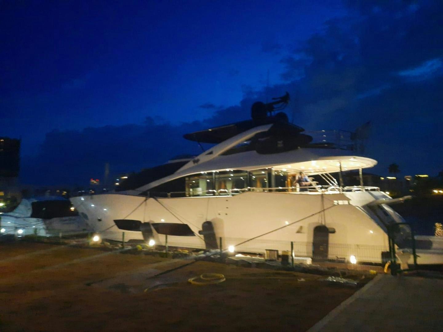 a large white boat with lights on the side aboard RIII Yacht for Sale