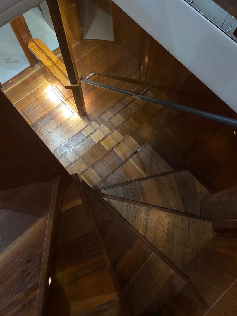 a staircase with wooden railings aboard RIII Yacht for Sale