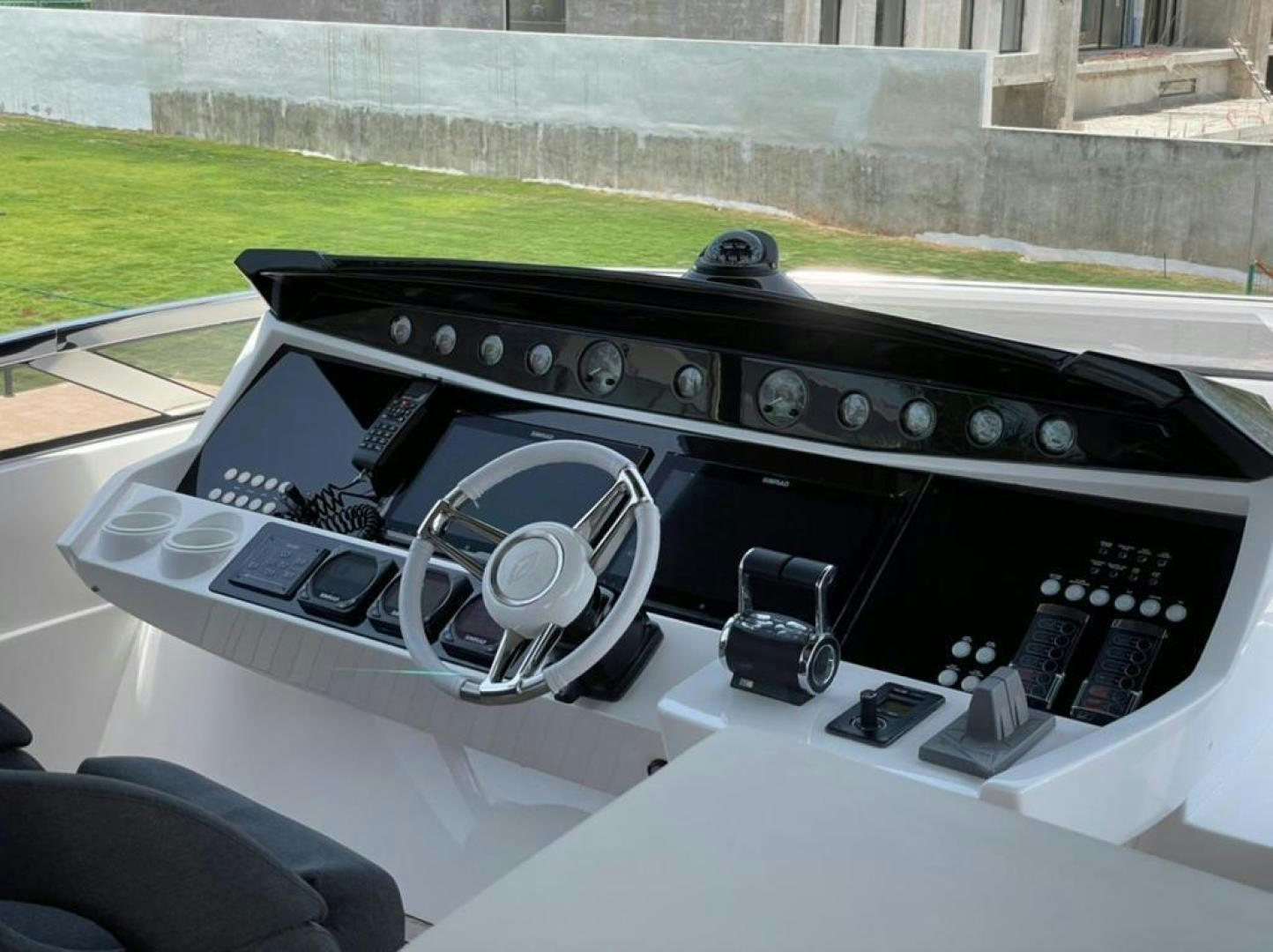 a black console with a white console and a black speaker on the side aboard RIII Yacht for Sale