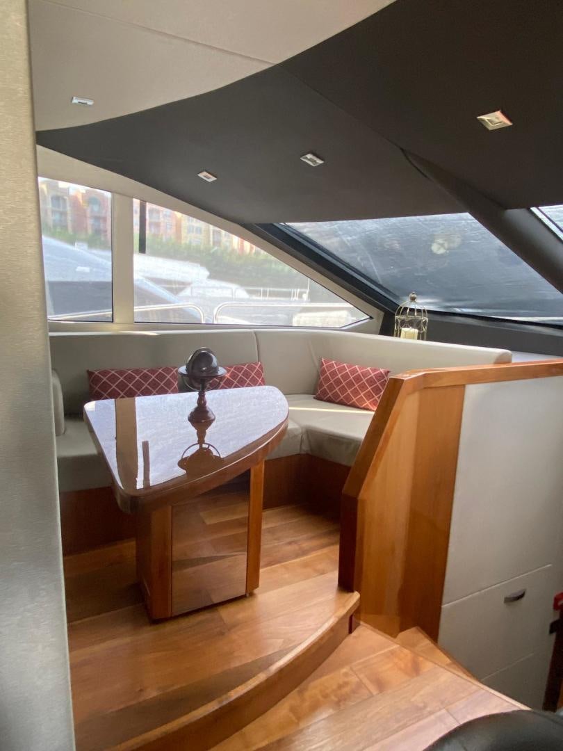 a table and chairs in a room aboard RIII Yacht for Sale