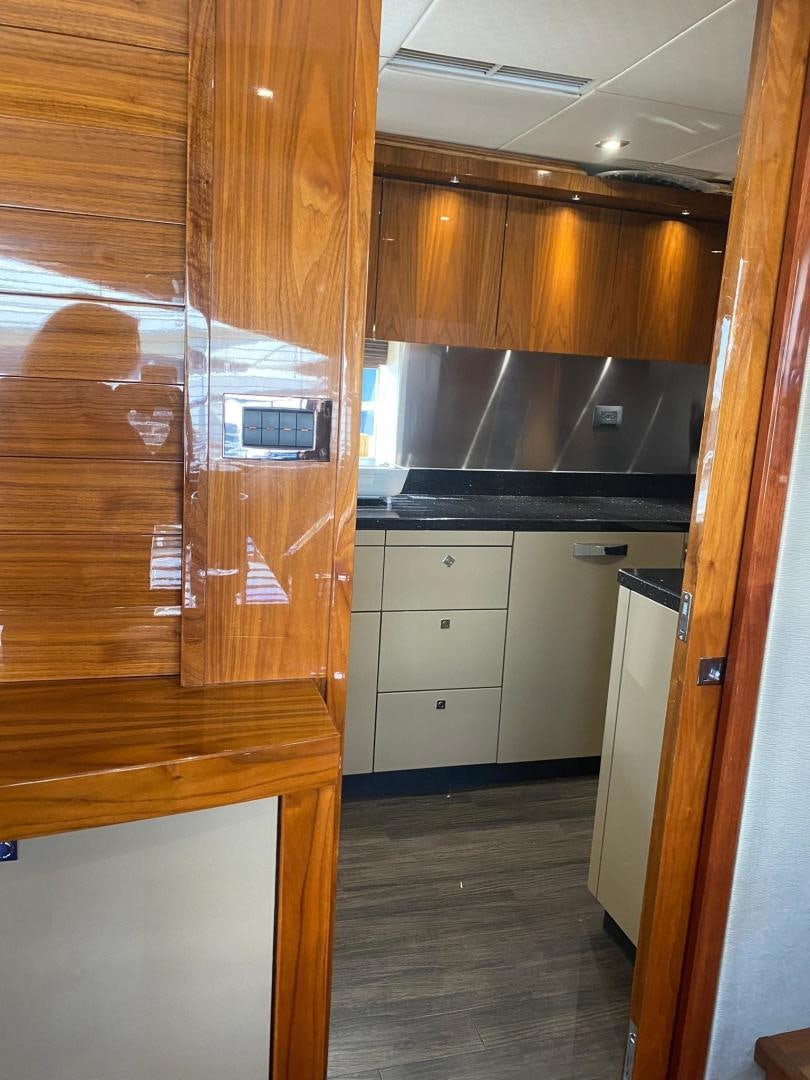 a kitchen with wooden cabinets aboard RIII Yacht for Sale