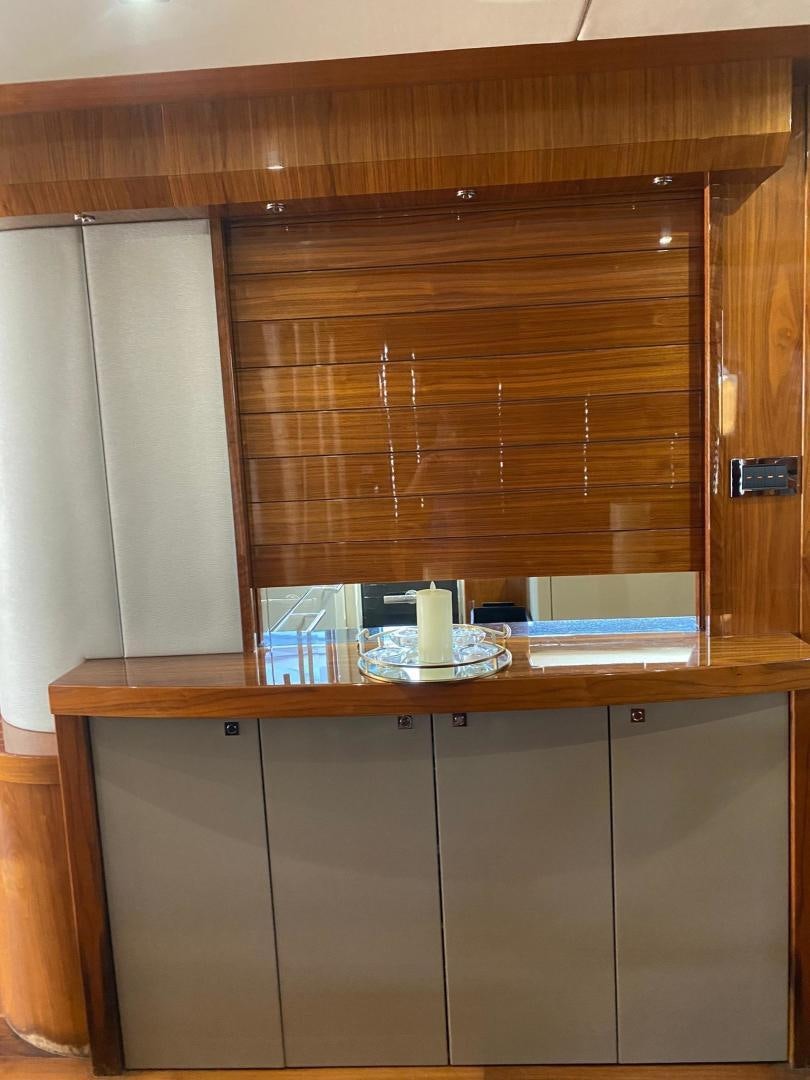 a wooden cabinet with a plate and a glass of milk aboard RIII Yacht for Sale