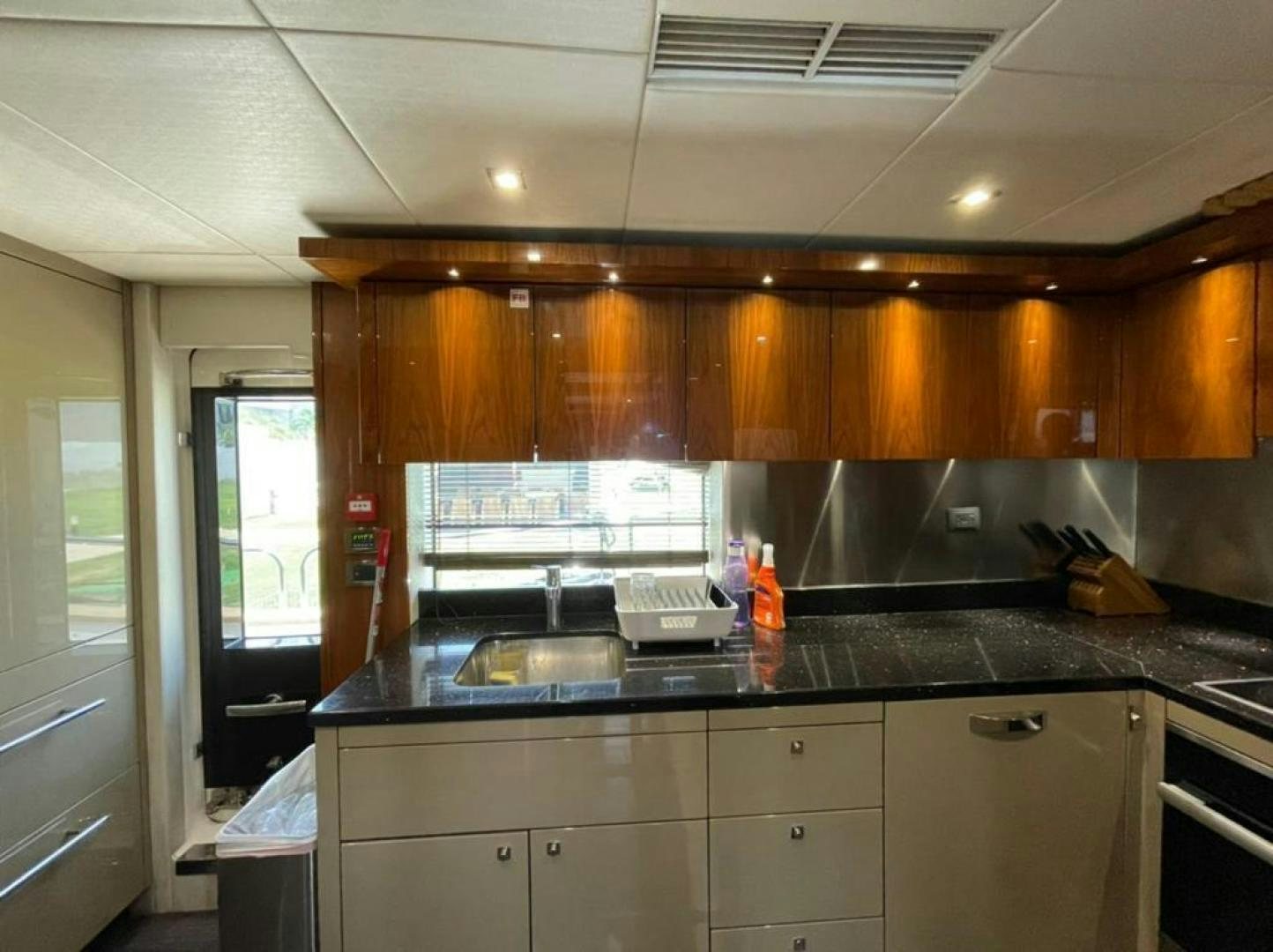a kitchen with wooden cabinets aboard RIII Yacht for Sale
