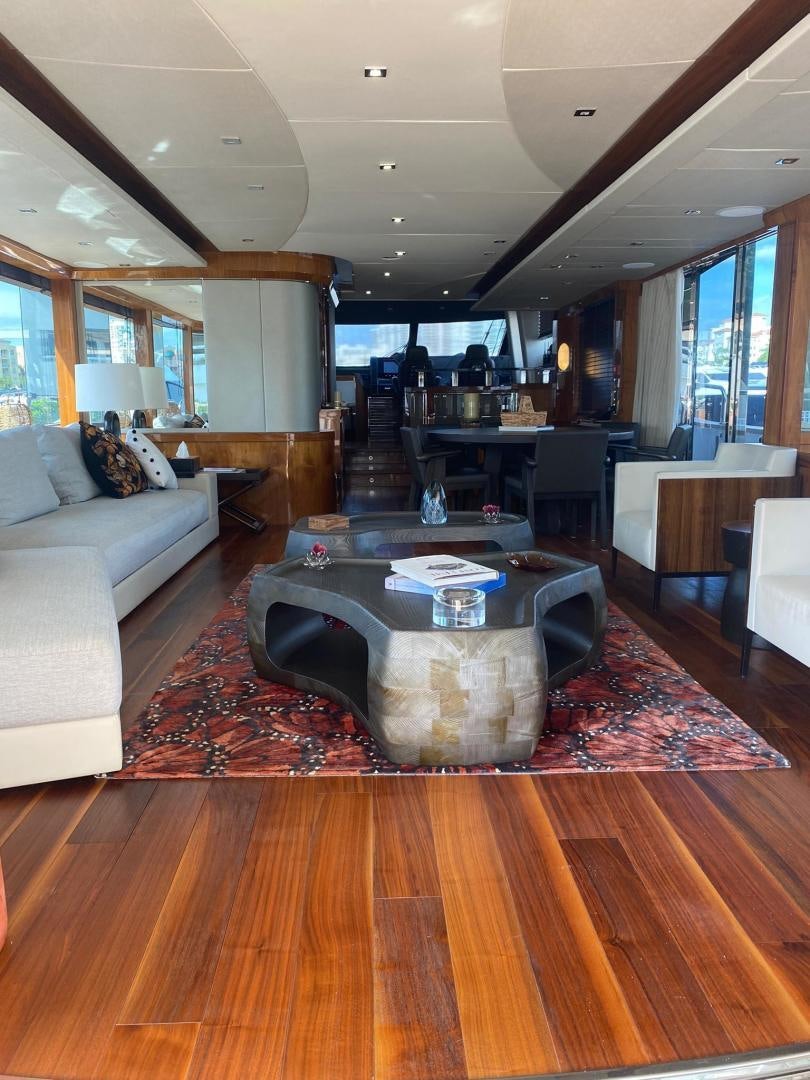 a living room with a large table aboard RIII Yacht for Sale