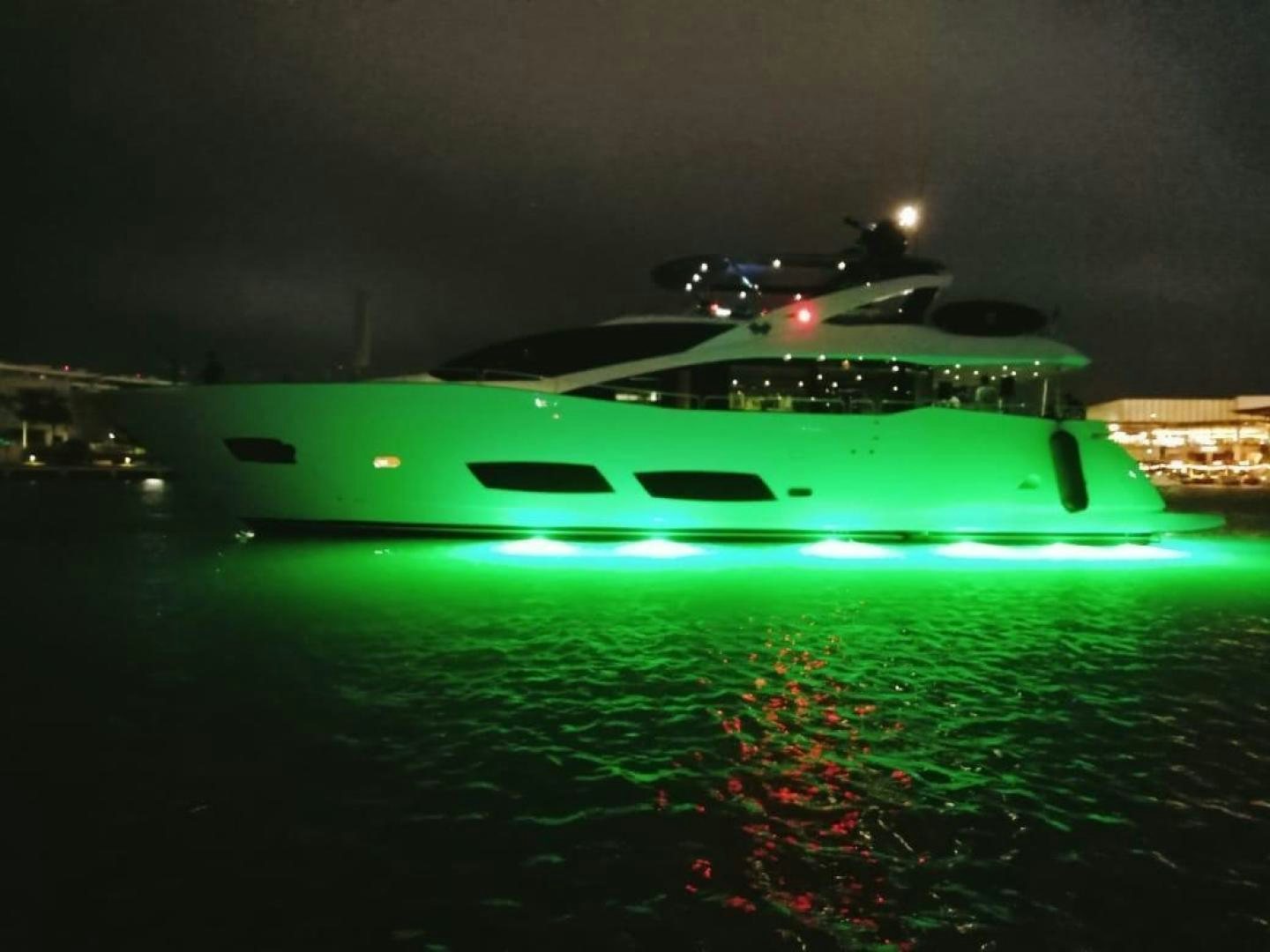 a green boat in the water aboard RIII Yacht for Sale