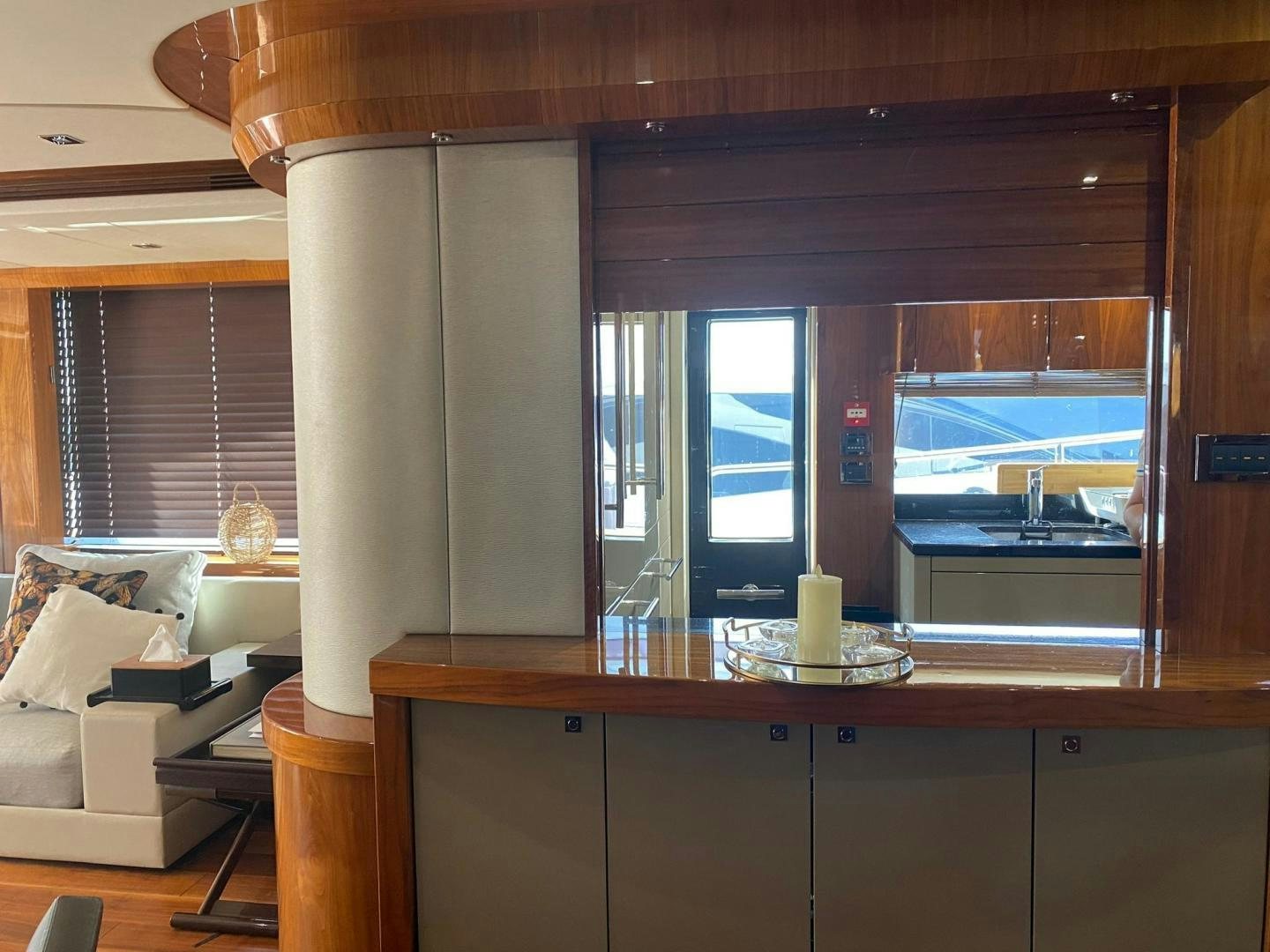 a room with a window and a table with a view of the water aboard RIII Yacht for Sale