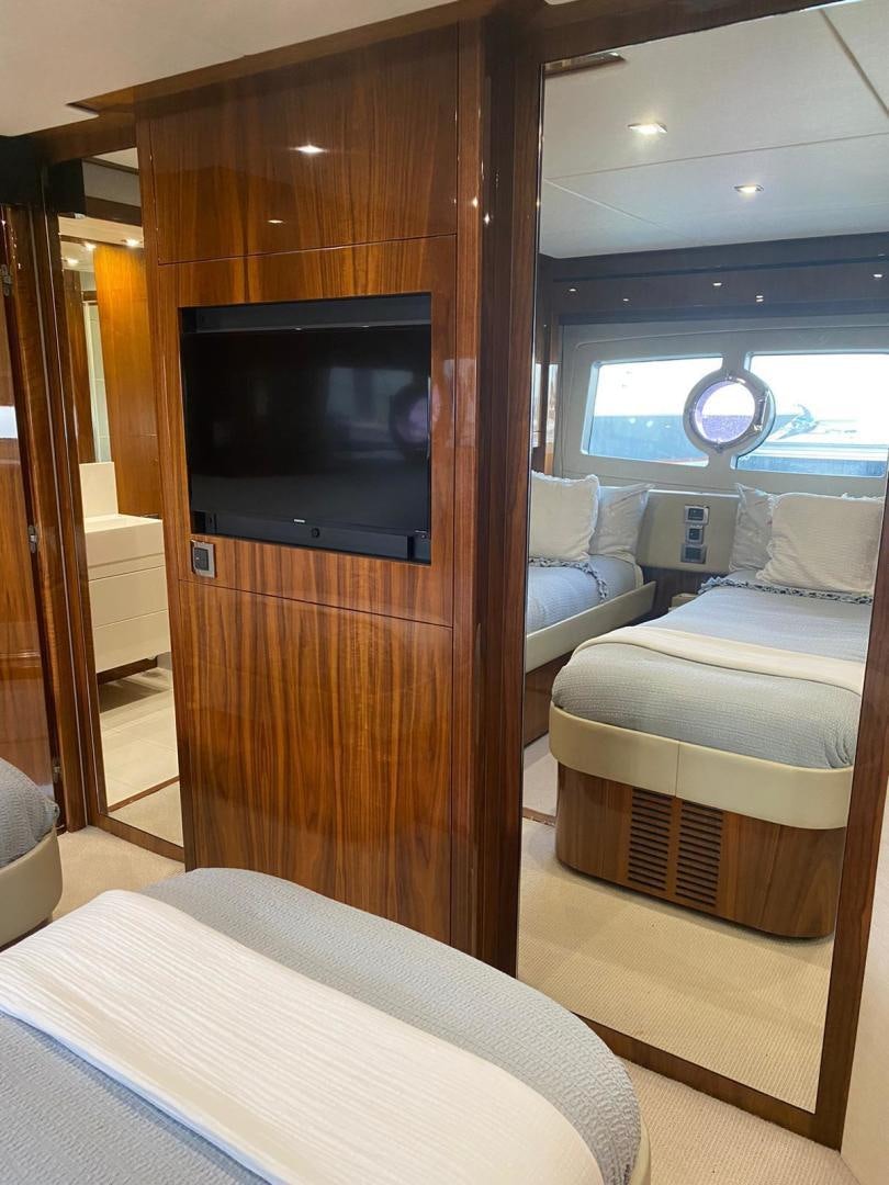 a living room with a tv aboard RIII Yacht for Sale